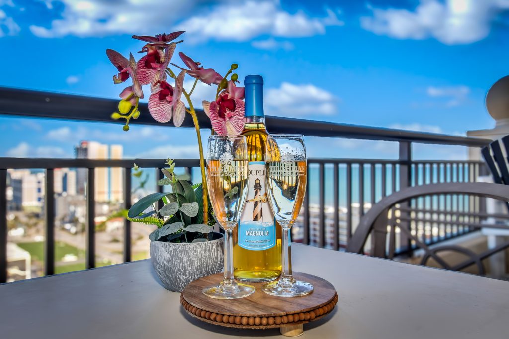 Wine bottles and champagne glasses overlooking North Myrtle beach.